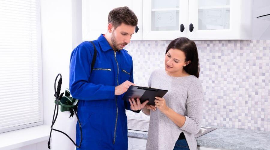 Pest control professional explaining services